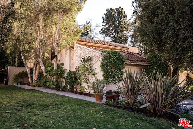 view of home's exterior with a lawn