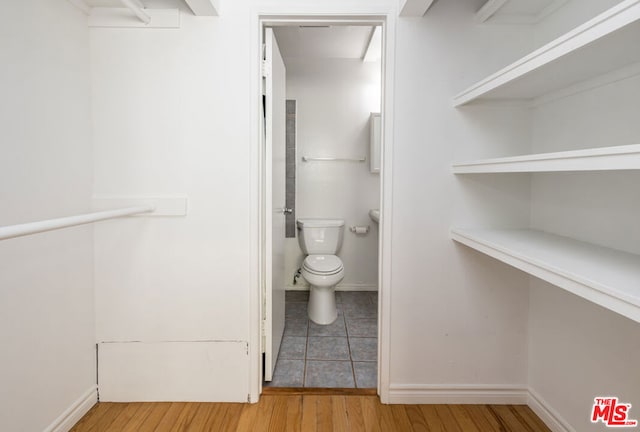 bathroom with wood-type flooring and toilet