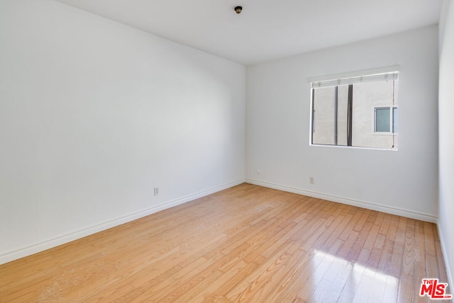 unfurnished room with light wood-type flooring