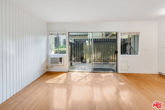 empty room with wood-type flooring and cooling unit