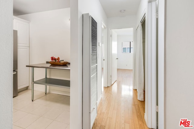 corridor with light hardwood / wood-style flooring