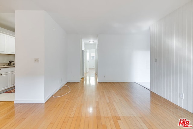 empty room with sink and light hardwood / wood-style flooring