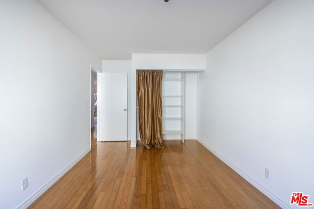 unfurnished room featuring hardwood / wood-style flooring