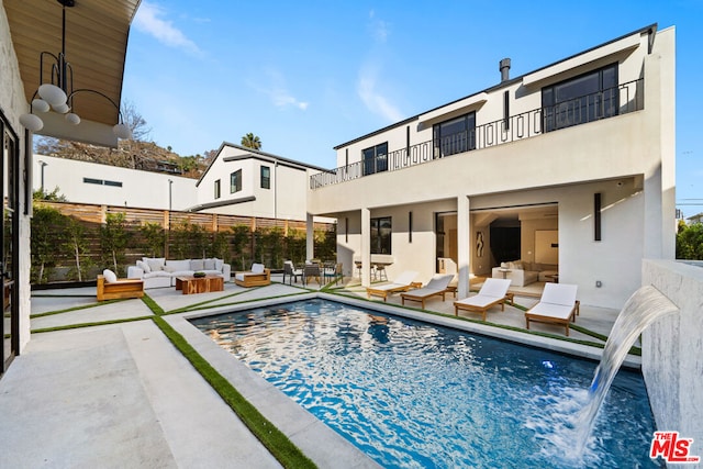 view of pool featuring a patio, outdoor lounge area, and pool water feature