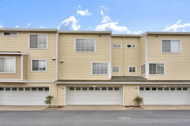 rear view of property featuring a garage