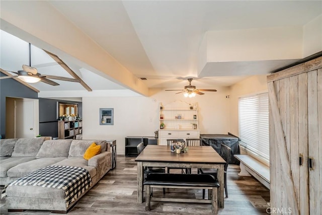 dining room with vaulted ceiling with beams, wood-type flooring, and ceiling fan