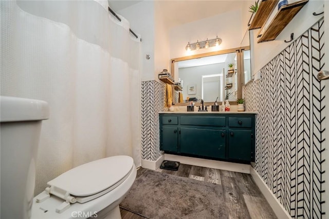 bathroom featuring vanity, hardwood / wood-style floors, and toilet