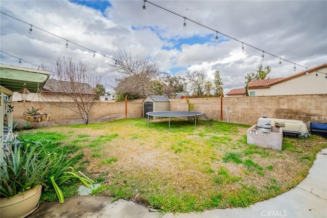 view of yard featuring a storage unit and a trampoline