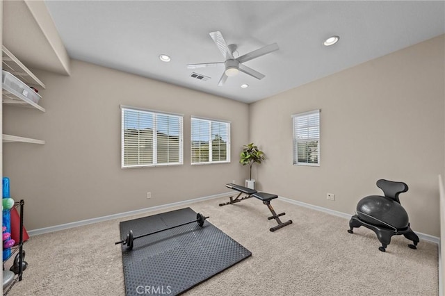 exercise area with light carpet and ceiling fan