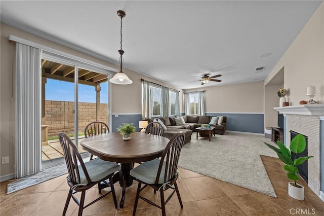 dining area featuring light tile patterned floors, plenty of natural light, and ceiling fan