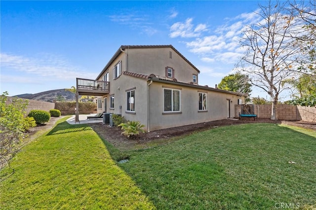 view of side of home with cooling unit, a mountain view, a yard, and a patio