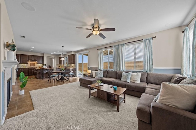 living room featuring plenty of natural light, ceiling fan, and light tile patterned flooring