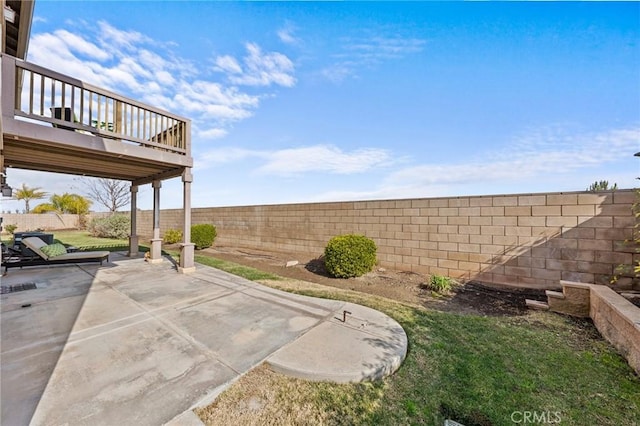 view of yard with a wooden deck and a patio