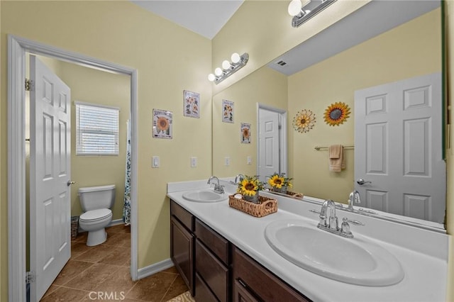 bathroom with vanity, tile patterned floors, and toilet