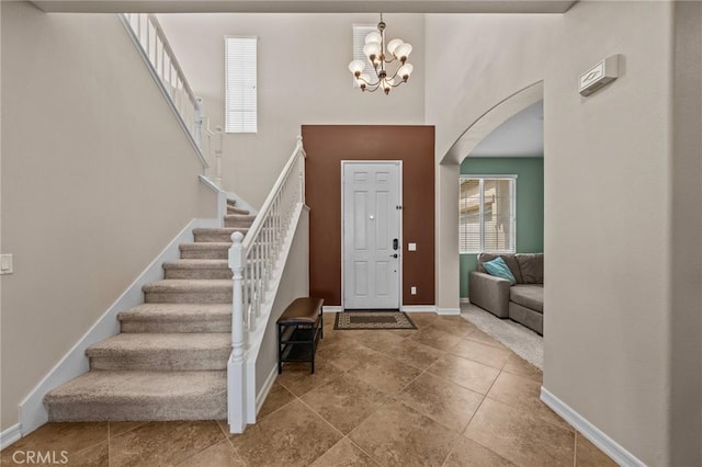 foyer with tile patterned flooring and a chandelier