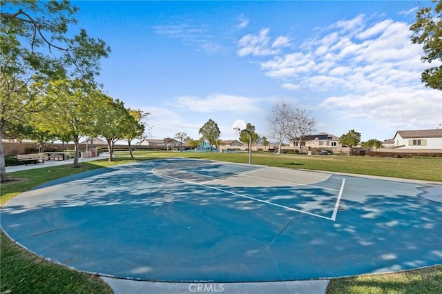 view of sport court with a yard