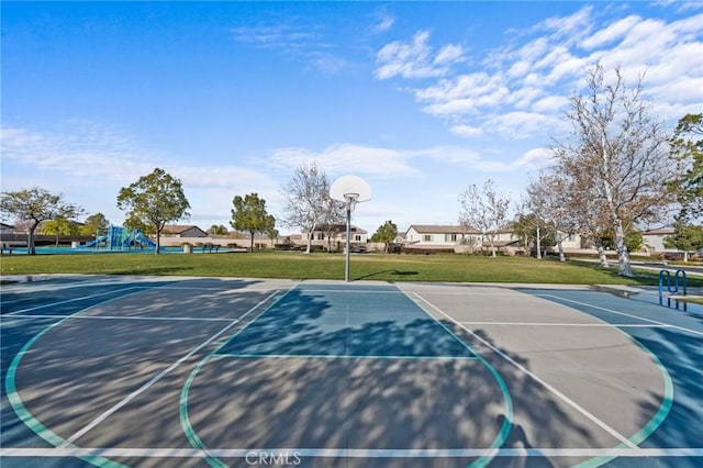 view of sport court with a playground and a yard