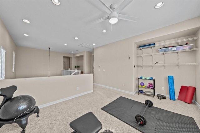 workout area with light carpet and ceiling fan