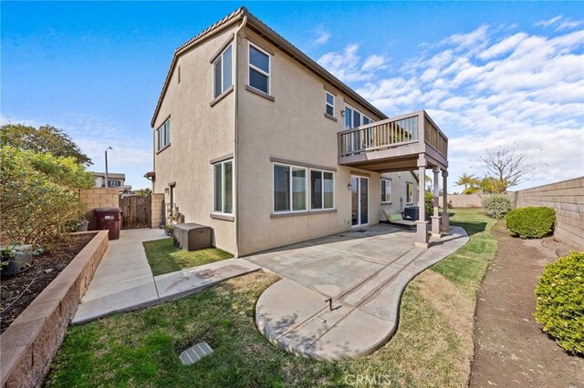 rear view of house featuring a patio area and a deck