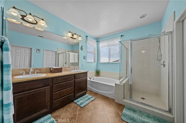 bathroom with vanity, tile patterned floors, and shower with separate bathtub