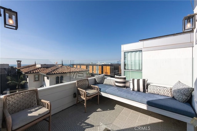 view of patio featuring an outdoor hangout area and a balcony