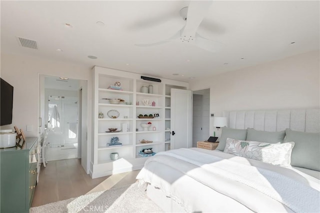 bedroom featuring connected bathroom, light hardwood / wood-style floors, and ceiling fan