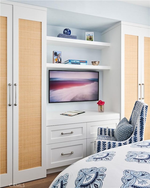 bedroom with dark hardwood / wood-style flooring