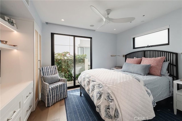 bedroom featuring dark hardwood / wood-style floors, access to outside, and ceiling fan