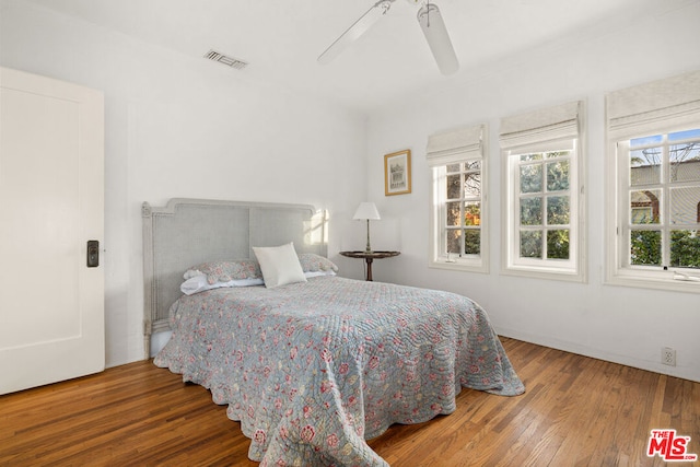 bedroom featuring hardwood / wood-style floors and ceiling fan