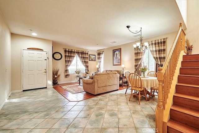 living area featuring recessed lighting, stairway, light tile patterned floors, a notable chandelier, and baseboards