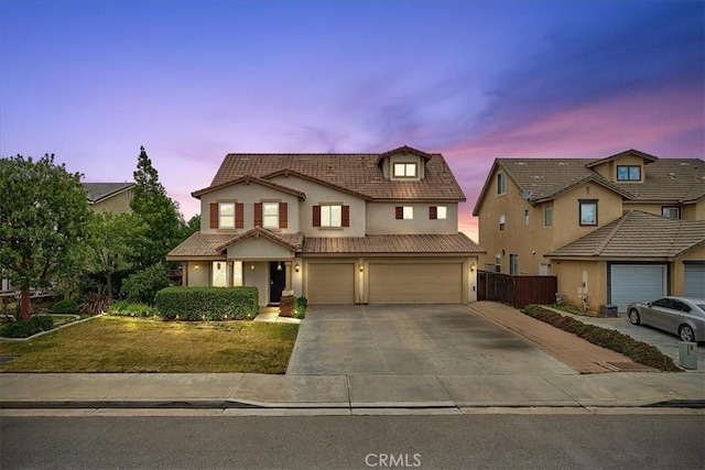 view of front of house with a garage and a yard