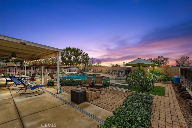8015 Ralston Pl, Riverside, CA 92508 - patio terrace at dusk with a patio, a fenced backyard, and a ceiling fan