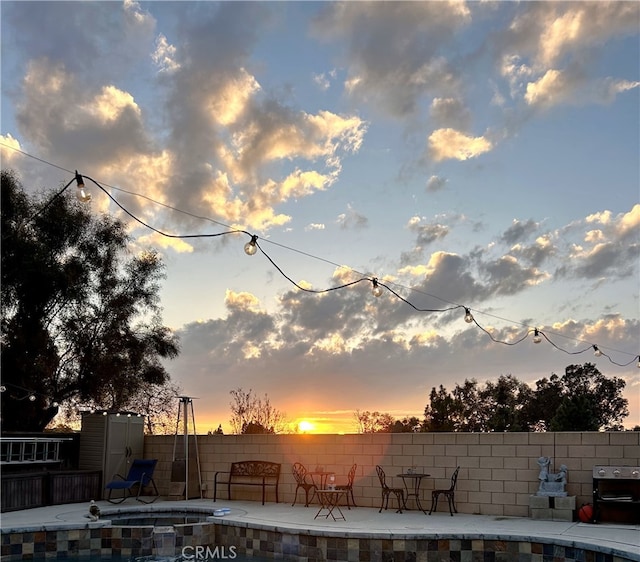 8015 Ralston Pl, Riverside, CA 92508 - pool at dusk featuring a patio area and area for grilling
