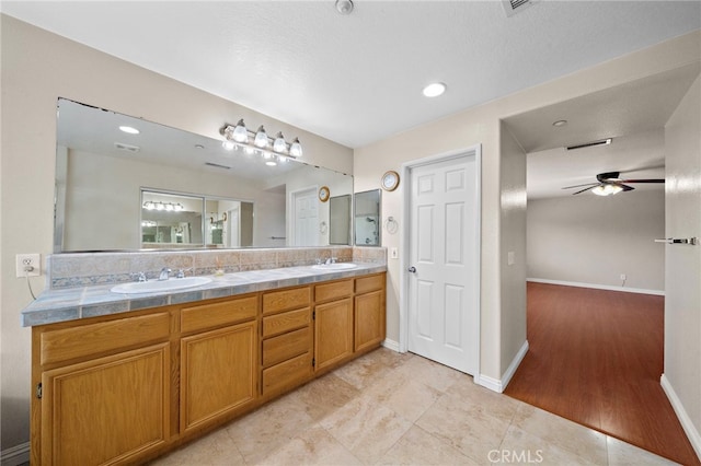 8015 Ralston Pl, Riverside, CA 92508 - bathroom featuring a ceiling fan, double vanity, baseboards, and recessed lighting
