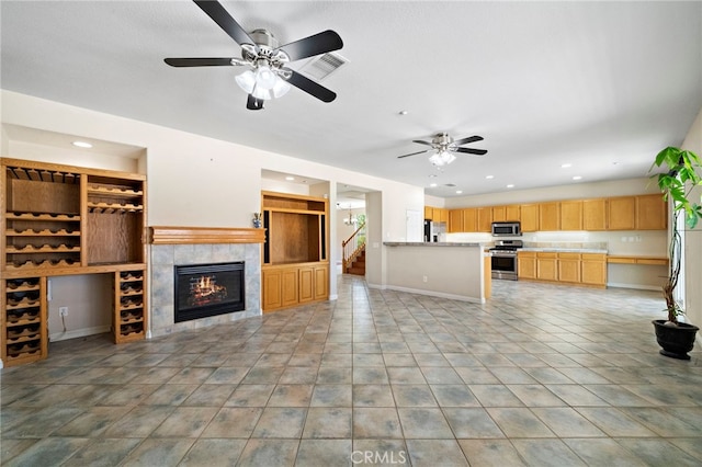 8015 Ralston Pl, Riverside, CA 92508 - unfurnished living room featuring baseboards, recessed lighting, a ceiling fan, a tile fireplace, and stairs