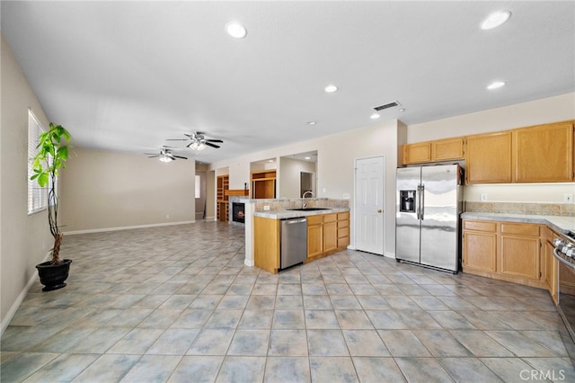 8015 Ralston Pl, Riverside, CA 92508 - kitchen featuring appliances with stainless steel finishes, ceiling fan, light countertops, open floor plan, and a sink