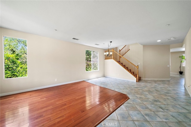 8015 Ralston Pl, Riverside, CA 92508 - unfurnished living room with a chandelier, baseboards, and stairway
