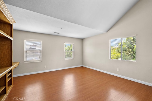 8015 Ralston Pl, Riverside, CA 92508 - unfurnished living room featuring wood finished floors, baseboards, and lofted ceiling