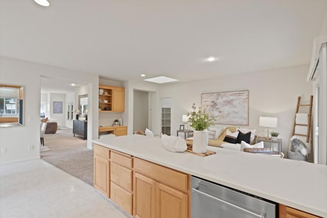 kitchen featuring light colored carpet, light brown cabinetry, and dishwasher