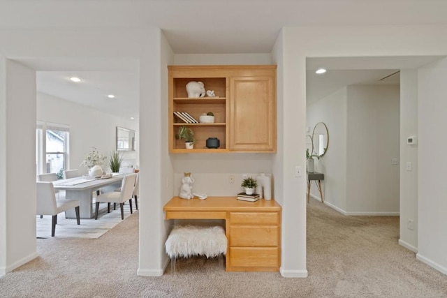 office area with built in desk and light carpet