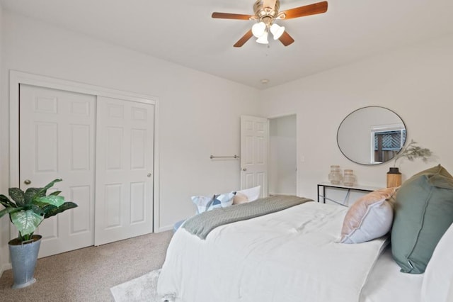 carpeted bedroom with ceiling fan and a closet