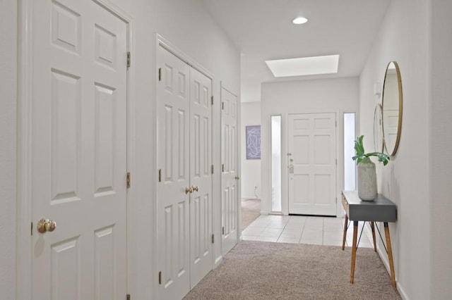 carpeted entryway with a skylight