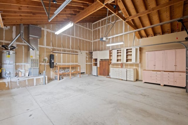 garage featuring a garage door opener and water heater