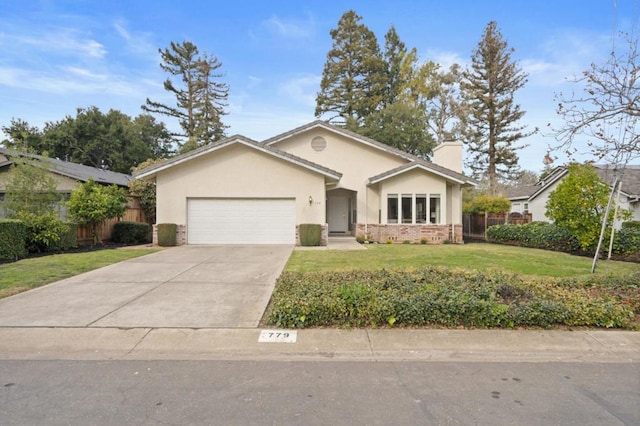 view of front of property featuring a garage and a front lawn