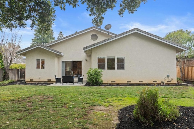 rear view of house with a yard and a patio