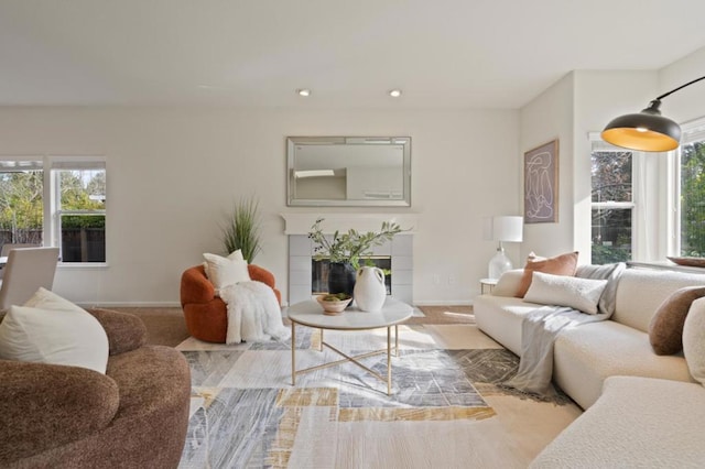 carpeted living room with a tiled fireplace