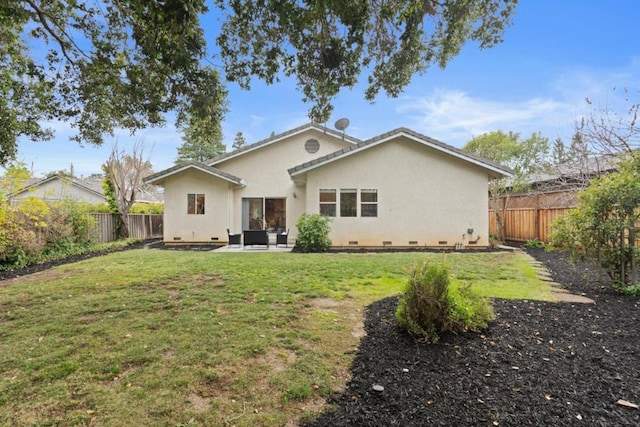 rear view of house with a patio and a yard