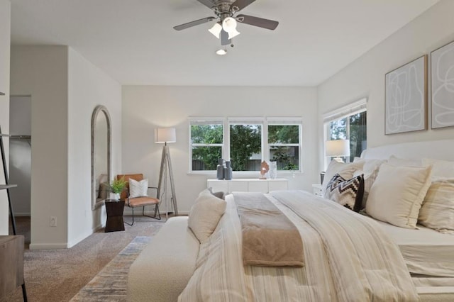 bedroom featuring ceiling fan and light carpet