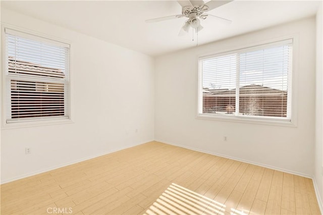 spare room with ceiling fan and light hardwood / wood-style floors