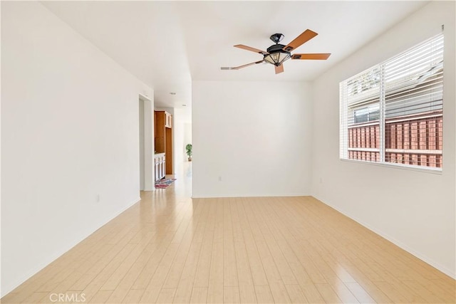 empty room featuring light hardwood / wood-style flooring and ceiling fan